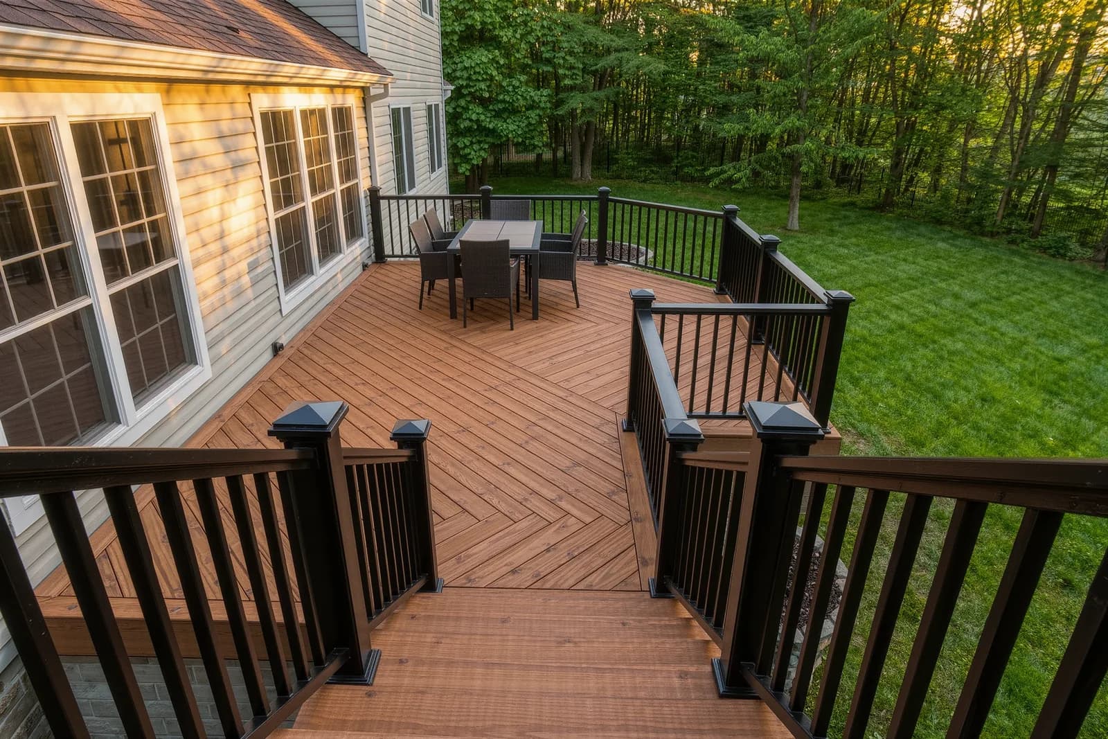 Newly built composite deck with black aluminum railings on the back of a suburban Maryland home