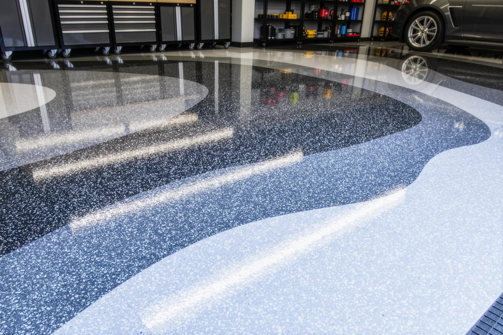 Freshly coated garage floor with gray and white decorative flake polyaspartic epoxy coating
