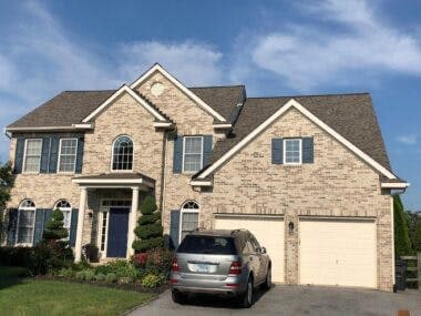 Roofing crew installing new shingles